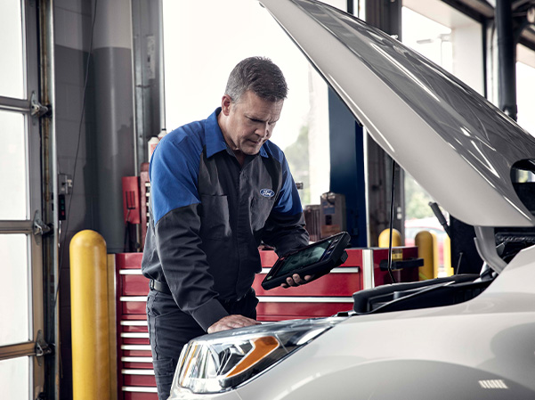 Service member inspecting car