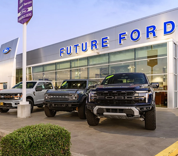 Front of dealership with lineup of cars