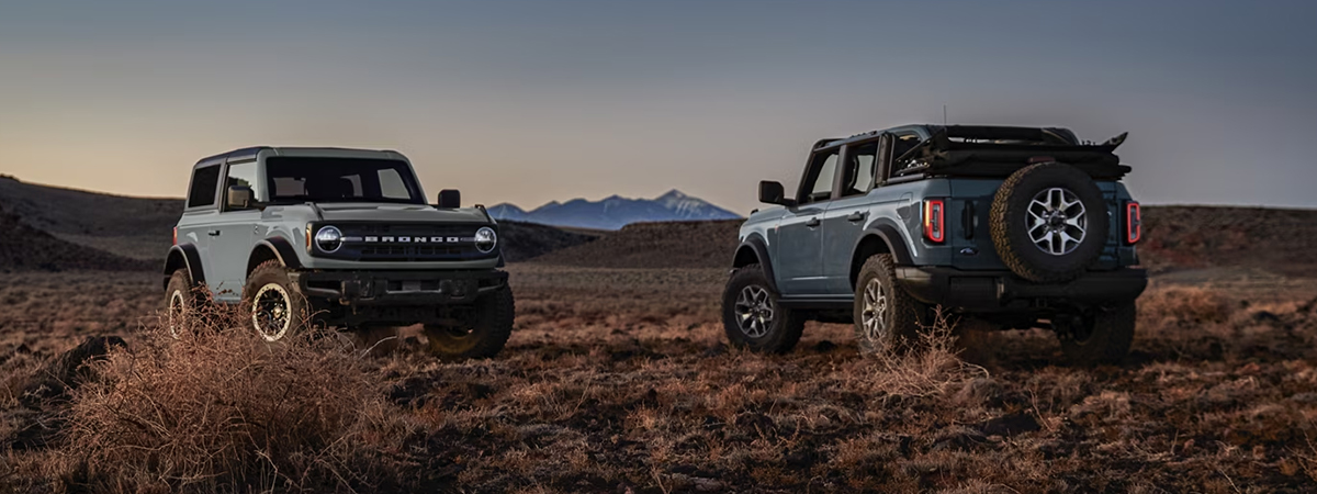two 2024 Ford Broncos parked outside at dusk 