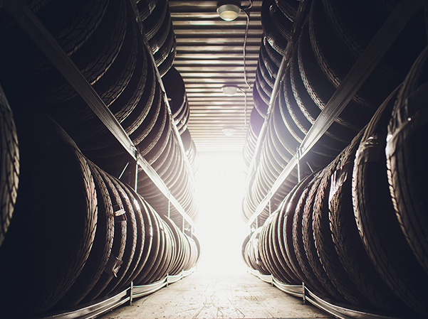 Storage room full of new tires on racks.