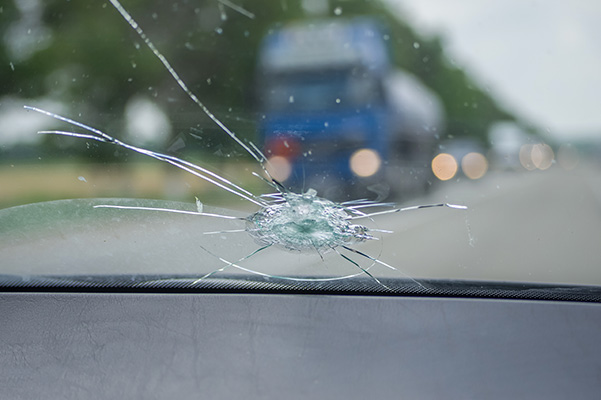 Up close shot of big crack in windshield of car
