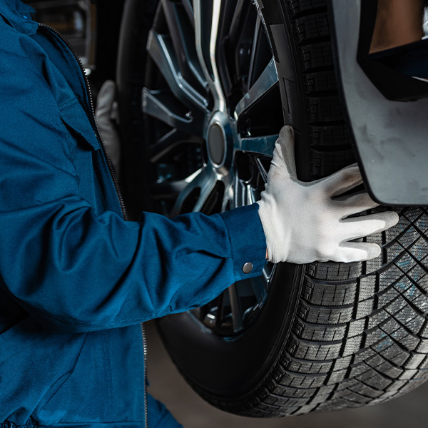 Tire being installed onto vehicle in service center