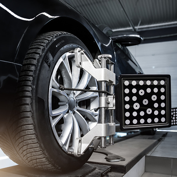 Detail shot of tires being aligned in service center
