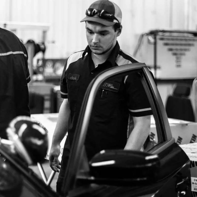 Buster Miles Upfitted employee opening the door of a vehicle
