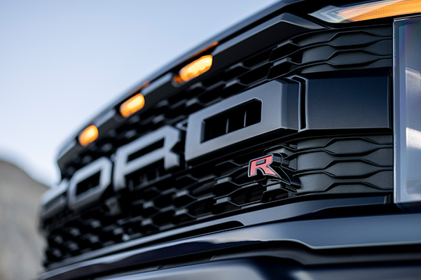 Up close front bumper shot of 2023 Ford F-150 Raptor badges.