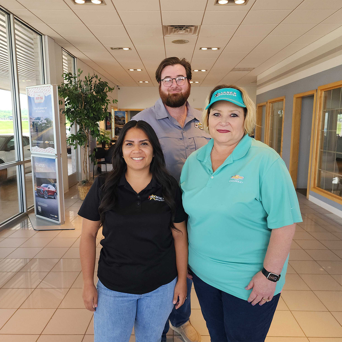 Dealership employee handing a clipboard to the customer with keys on it
