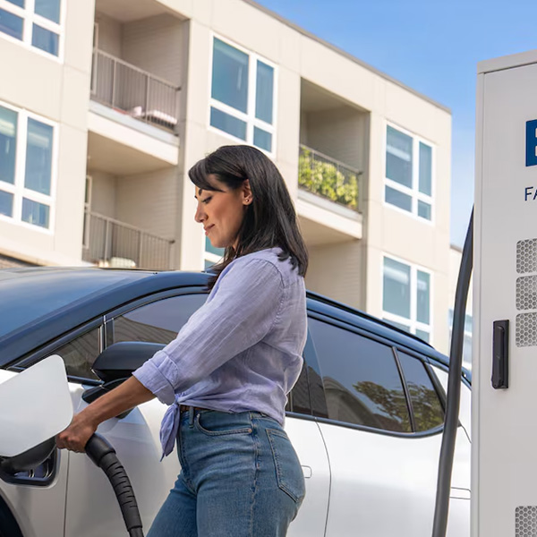 Happy woman charging her Chevy EV