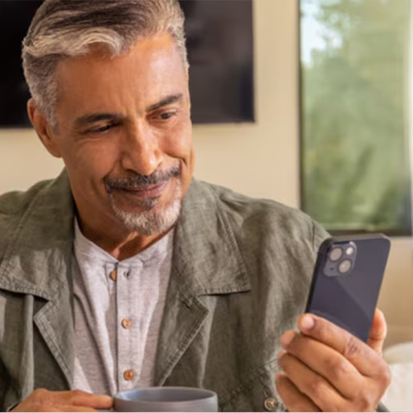 Man on his cellphone with support