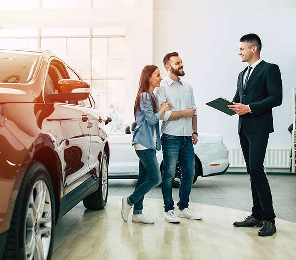 Associate helping customers with a car
