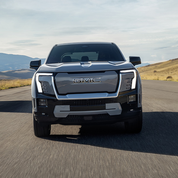 Head on shot of the GMC Sierra EV driving down road